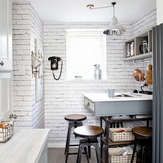 kitchen with telephone on white brick wall