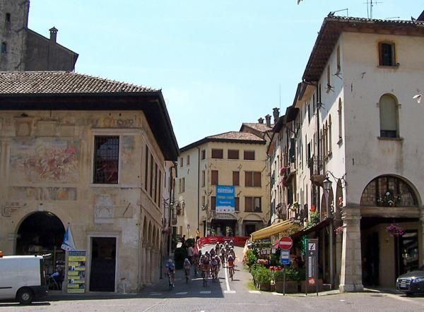 Riders head through the center of town of the third lap.