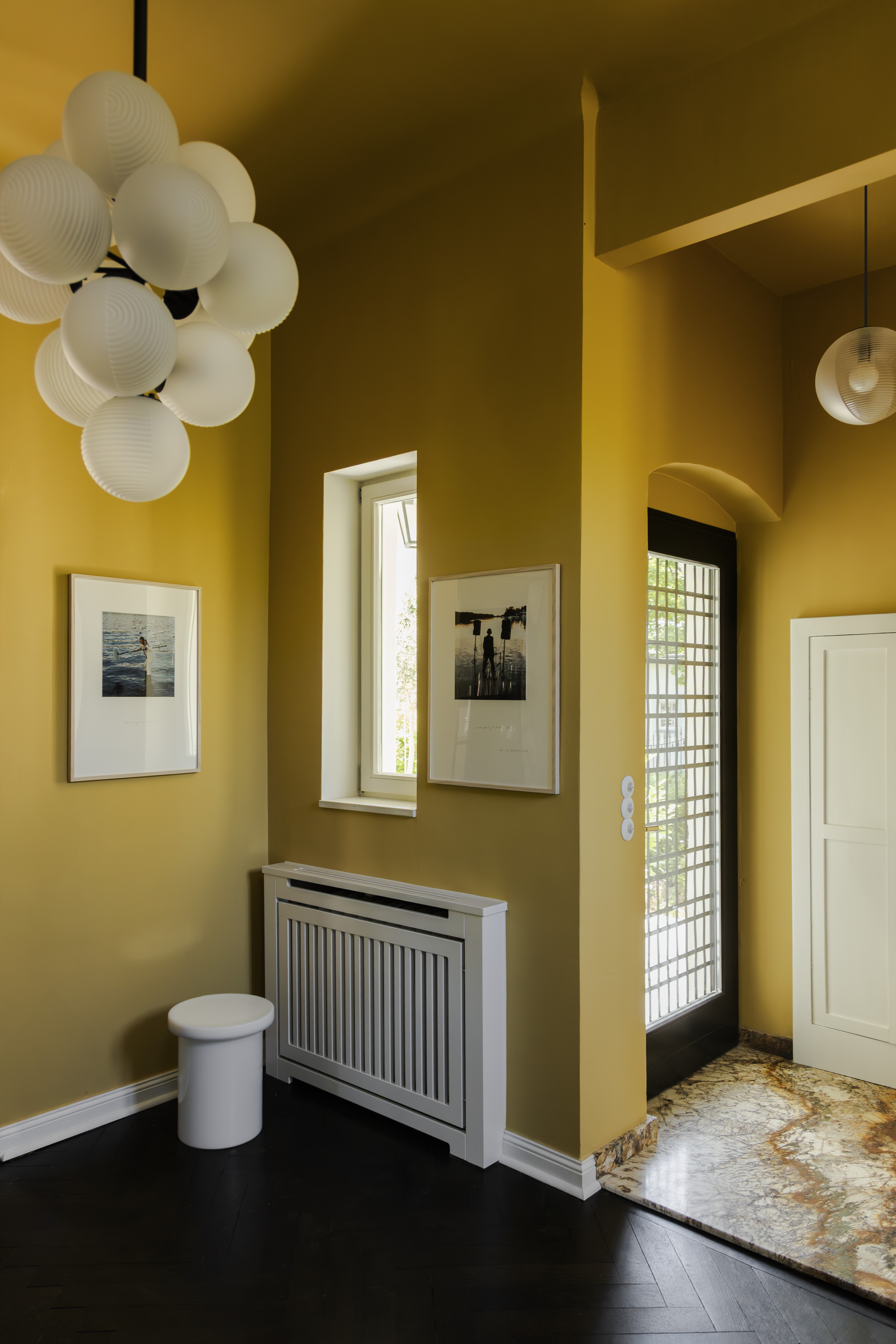 Balancedly designed interiors with plenty of natural light, pastel palettes, sculptural pieces, and curated artwork, with floor-to-ceiling walls and arched walls.