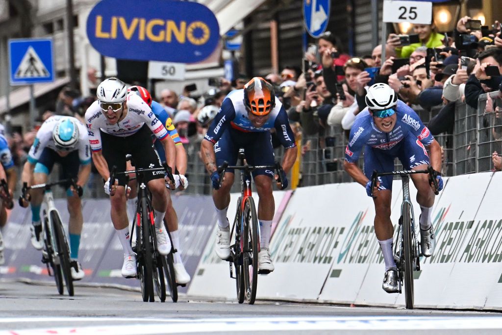 Alpecin-Deceuninck's Belgian rider Jasper Philipsen (R) cycles to cross the finish line ahead of UAE Team Emirates' Slovenian rider Tadej Pogacar (L) during the 115th Milan-SanRemo one-day classic cycling race, between Pavia and SanRemo, on March 16, 2024. (Photo by Marco BERTORELLO / AFP)