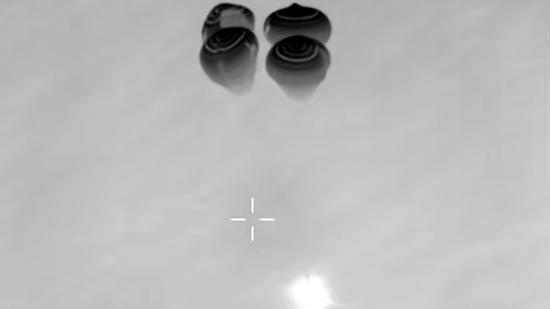 a black and white image of a cone hanging from four parachutes