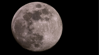 close-up of the moon with the black sky in behind