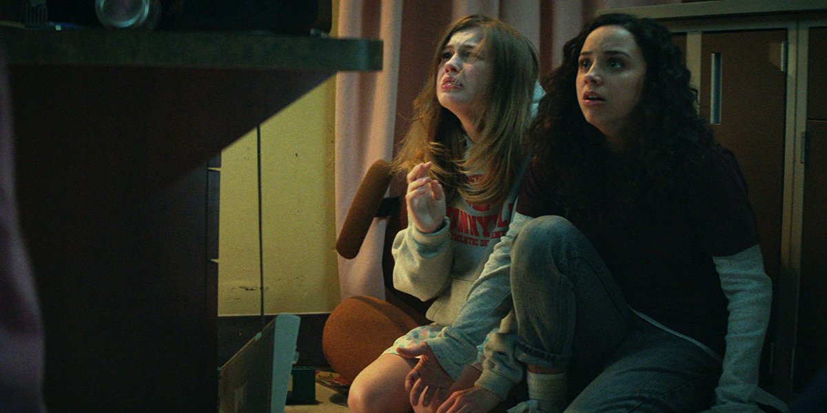 Olivia Welch and Kiana Madeira look up in horror in Fear Street: Part 1 - 1994.