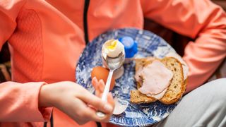 woman eating ham and egg on toast before a run