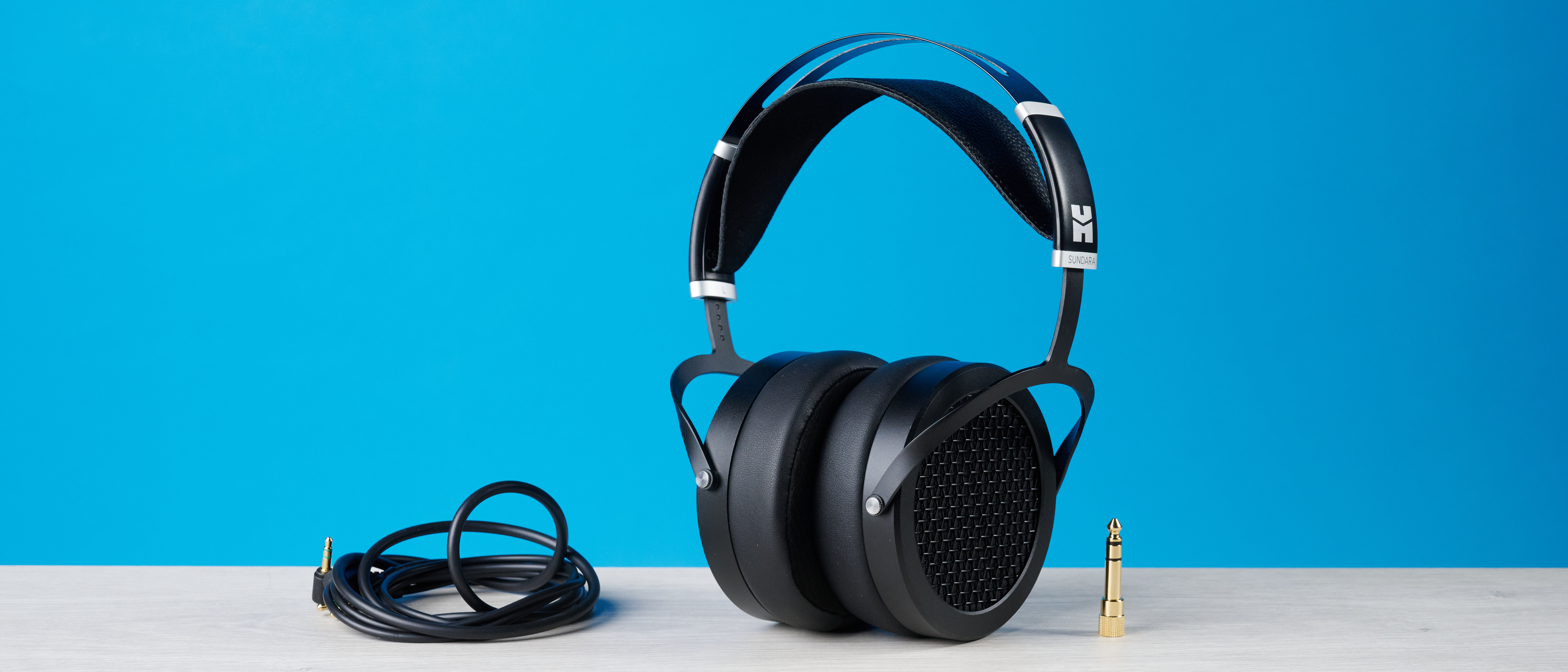 the HIFIMAN Sundara open-back wired audiophile headphones photographed against the blue toms' guide background