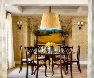 dining room with textured wallcovering with dark wood table and traditional chairs