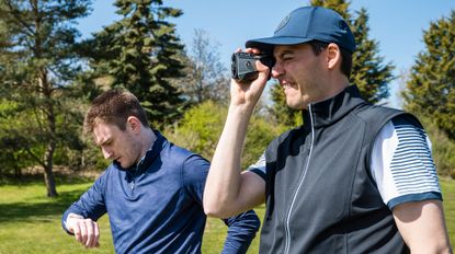 men using gps watch and laser rangefinder