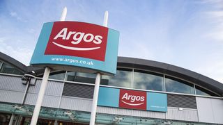 An Argos storefront with a sign bearing the Argos logo standing outside