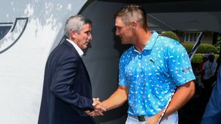 Jay Monahan and Bryson DeChambeau shake hands during the 2021 Tour Championship at East Lake