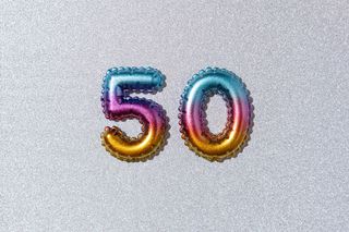 Multicolored numbers 50 on a silver background with glitter