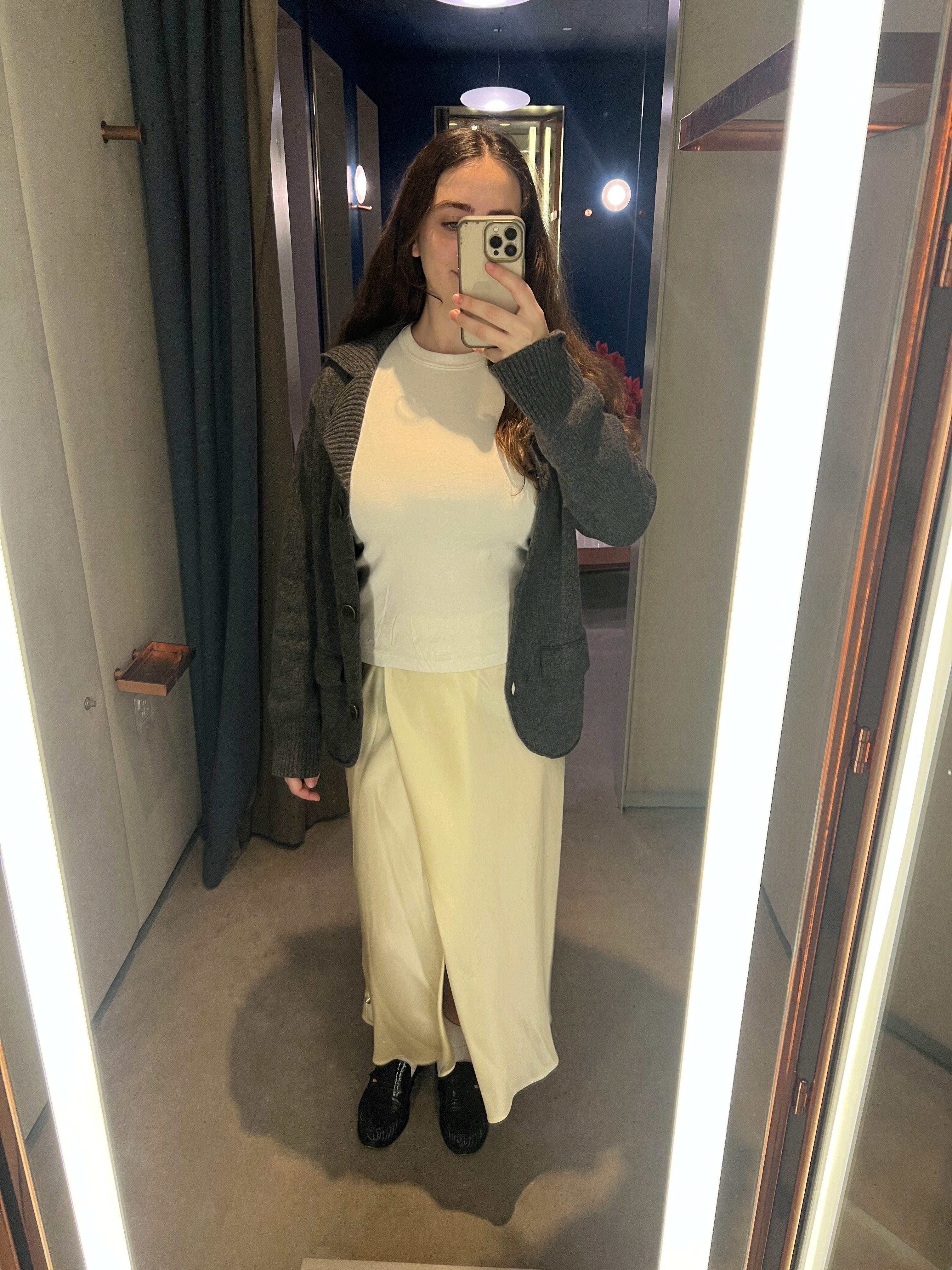 An image of Who What Wear UK's SEO Writer Ava Gilchrist wearing a satin skirt from Khaite .