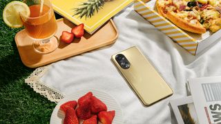 Oppo F23 5G phone on table surround by various food items