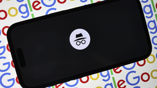 A Google Incognito Mode tab open on a mobile phone, set against a multi-color background made up of a repeating Google logo.