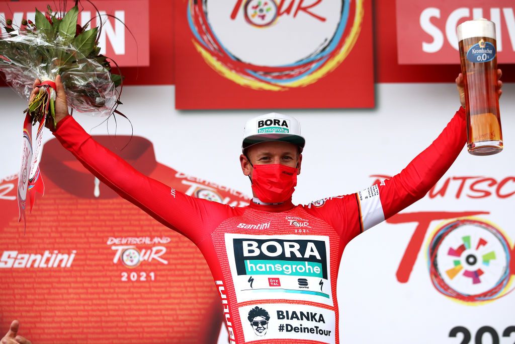 SCHWERIN GERMANY AUGUST 26 Pascal Ackermann of Germany and Team Bora Hansgrohe celebrates winning the Red Leader Jersey on the podium ceremony after the 35th Deutschland Tour 2021 Stage 1 a 191km stage from Stralsund to Schwerin DeineTour on August 26 2021 in Schwerin Germany Photo by Christian KasparBartkeGetty Images