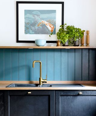 Country kitchen with green painted backsplash and shelf