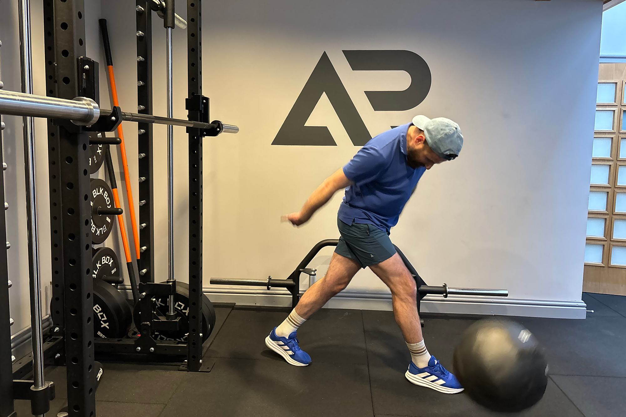 Baz Plummer slamming a medicine ball down into the ground