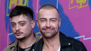 Andrew and Joey Lawrence posing on a carpet in 2017