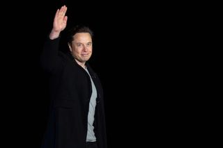 SpaceX CEO Elon Musk waves during an event at his company's Starbase facility in South Texas on Feb. 10, 2022.