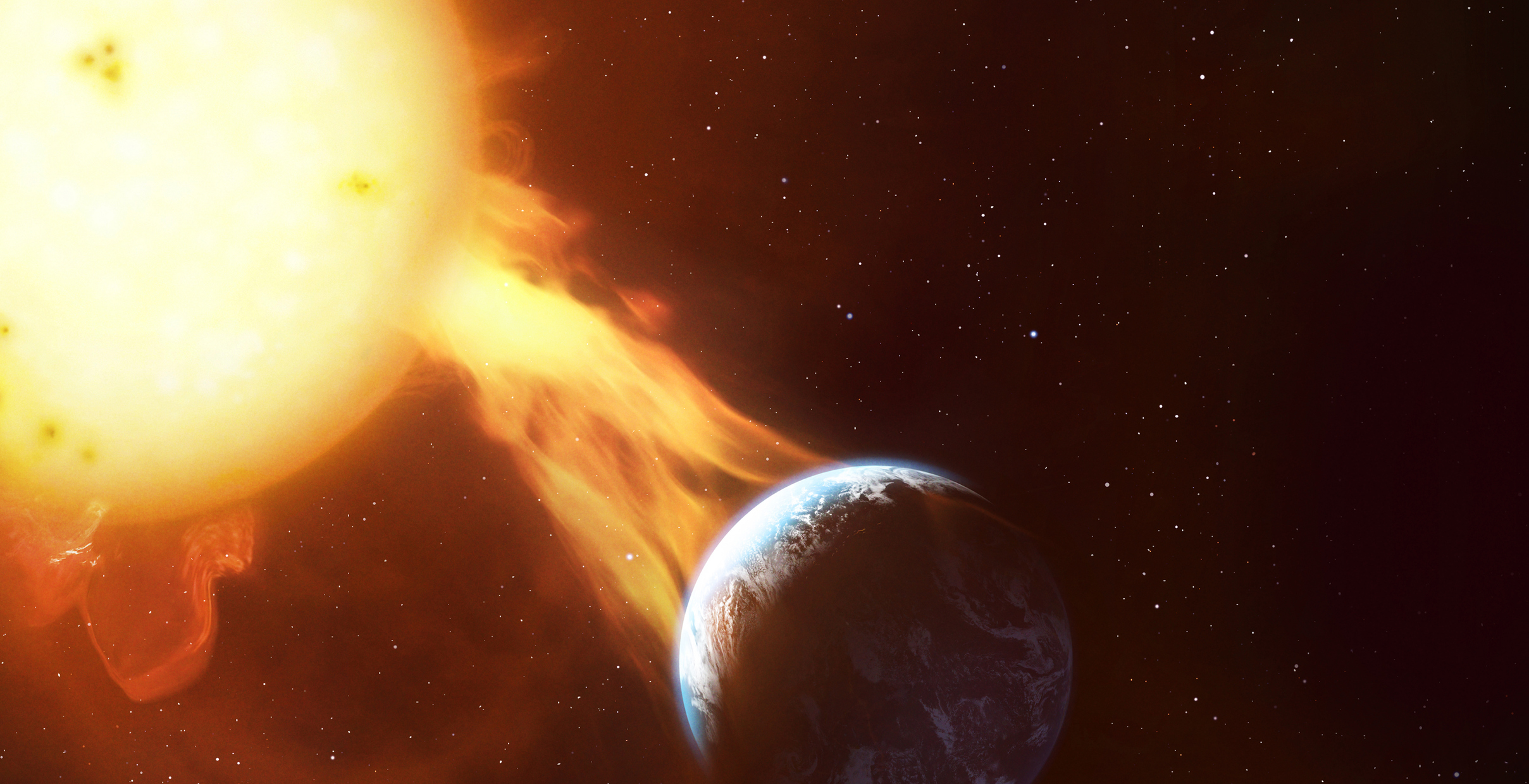 the sun erupts with a large flare-like explosion towards a blue and white planet