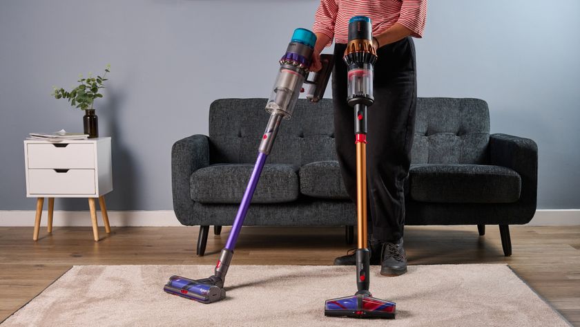 Person holding Dyson V16 and Gen5detect vacuums