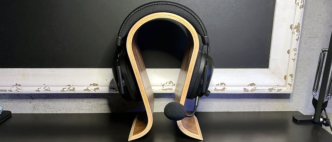 black wireless gaming headset on stand