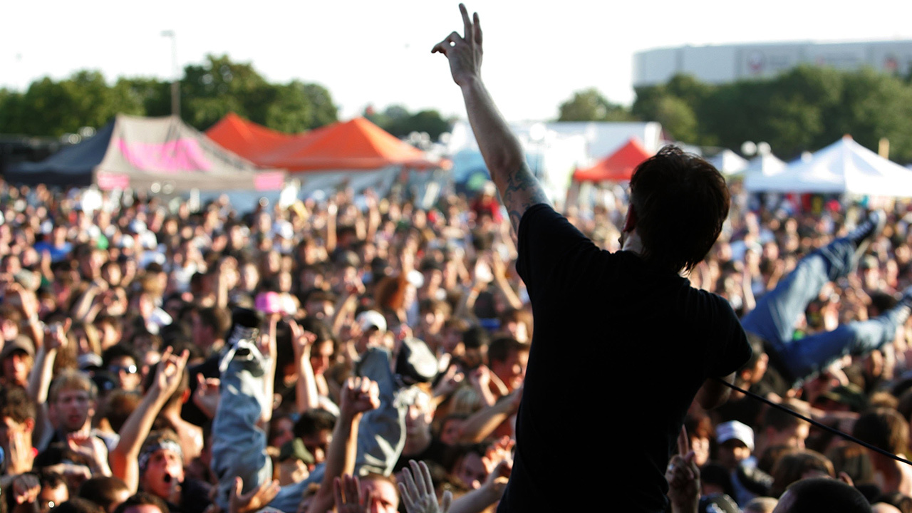 a picture of rise against and crowd at warped tour