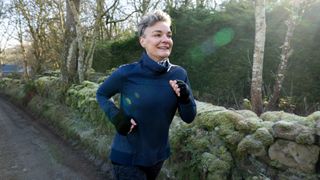 Woman running along countryside path