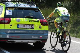 Alberto Contador rides near his team car before abandoning the Tour de France