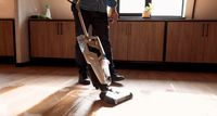 Is a wet/dry vacuum better than a mop? | person cleaning hard floor
