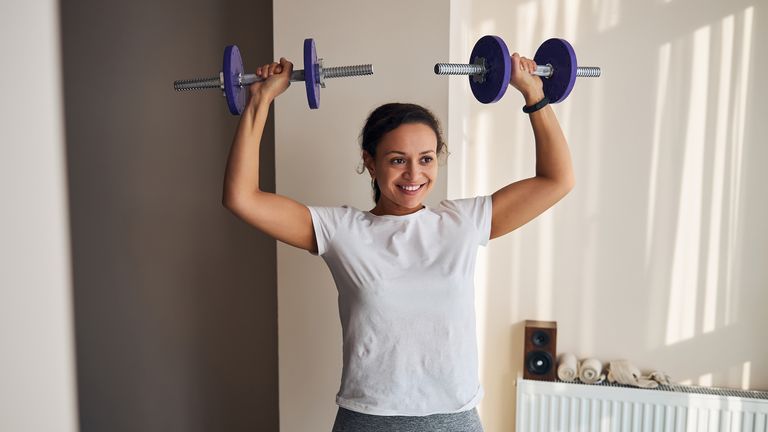 Woman performing a dumbbell press