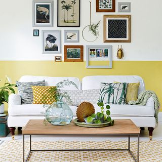 living room with yellow and white half painted wall