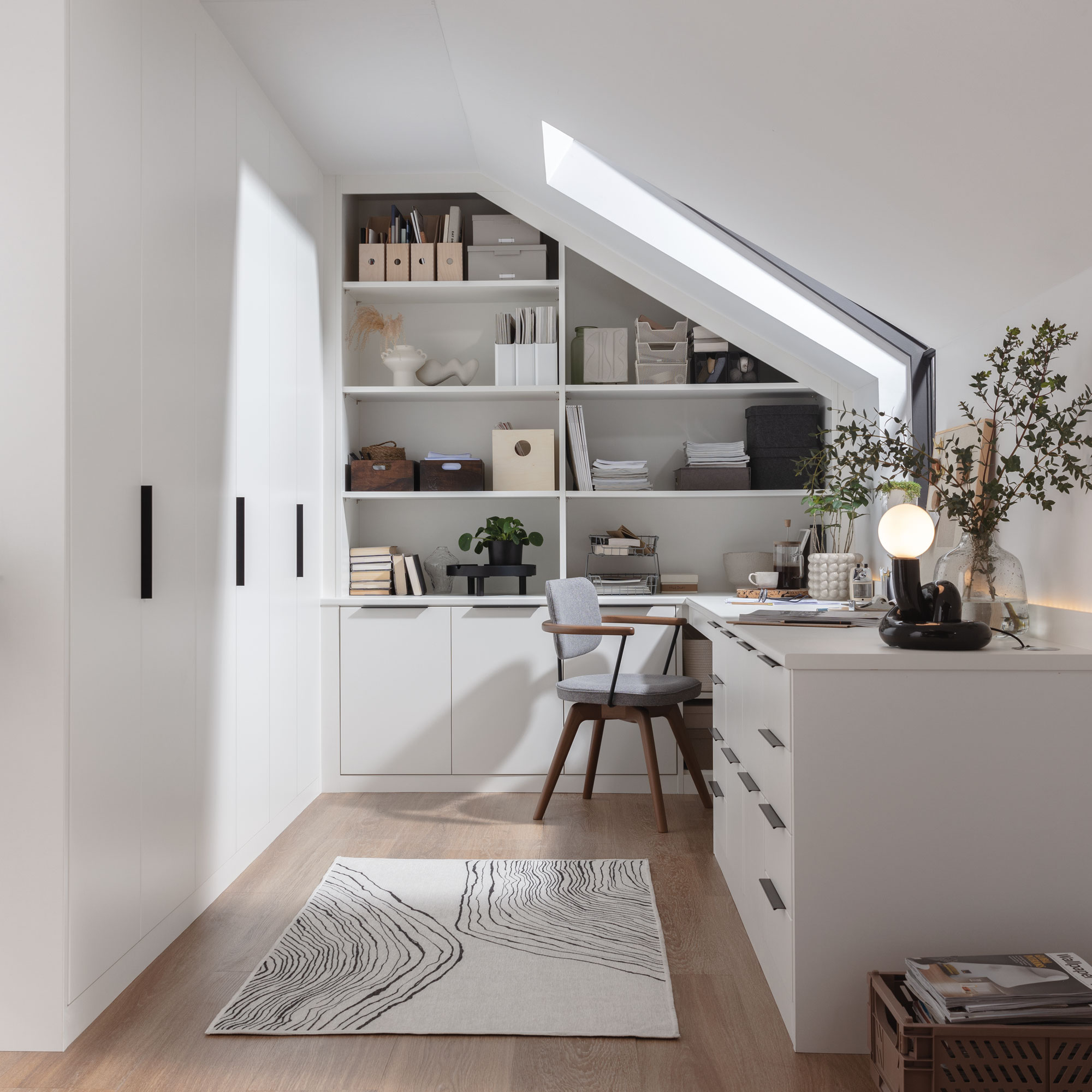 White home office with built in cabinets, shelves and a desk