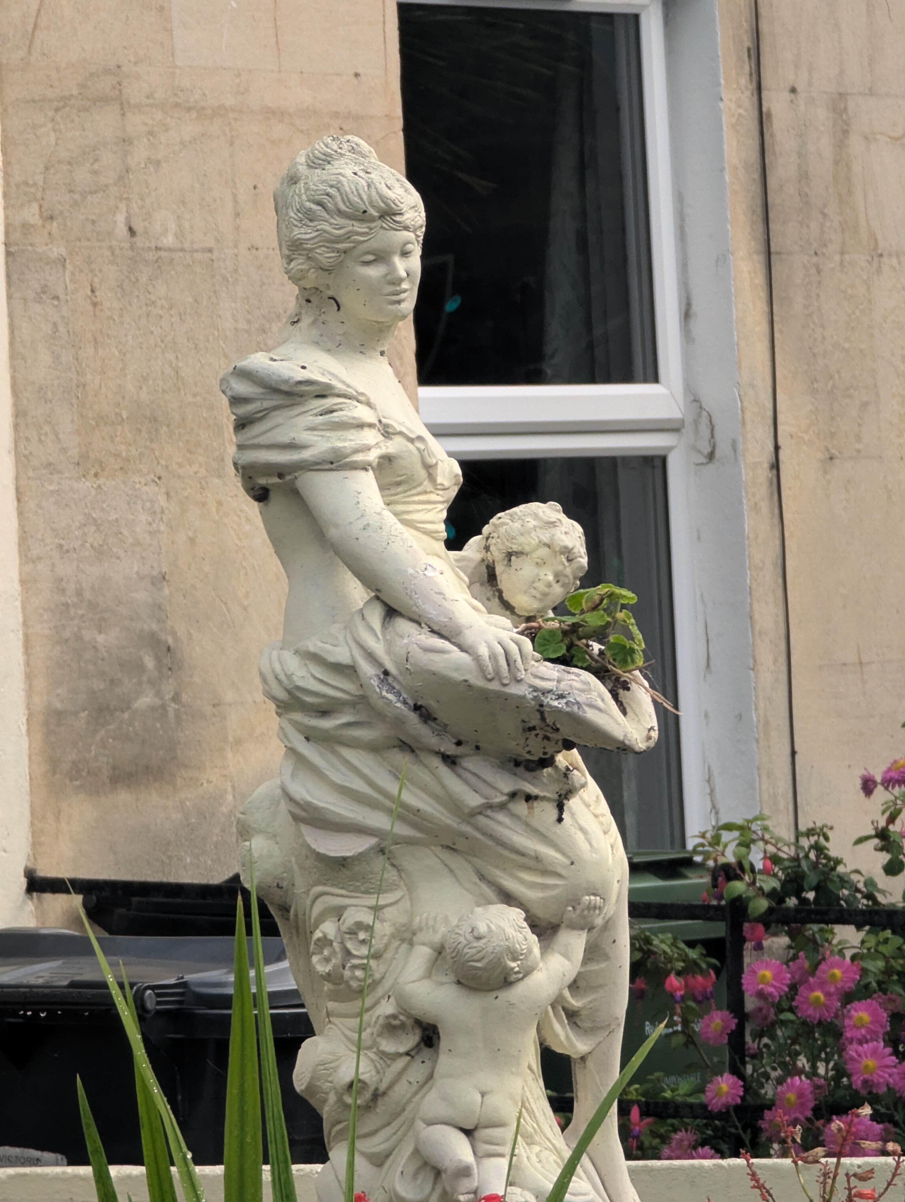 A photo of a statue a woman and children taken on a Google Pixel 7 Pro