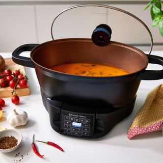 Russell Hobbs multi cooker cooking soup on worktop with food