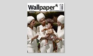 The cover of Wallpaper* magazine which has three woman wearing round hats and the middle woman is holding a baby in a diaper.