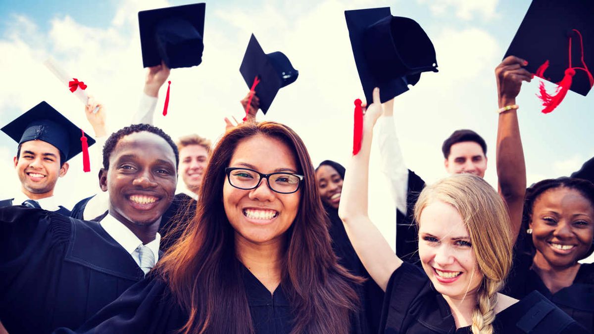 Graduates wave their caps