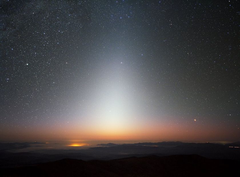 A photo of the night sky with a triangle-shaped ray of light