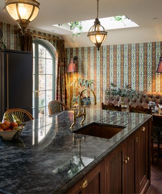 Maximalist kitchen with black countertops and wooden cabinets