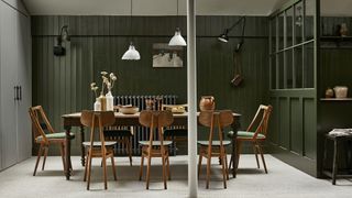 green dining room with wall and pendant ceiling lighting