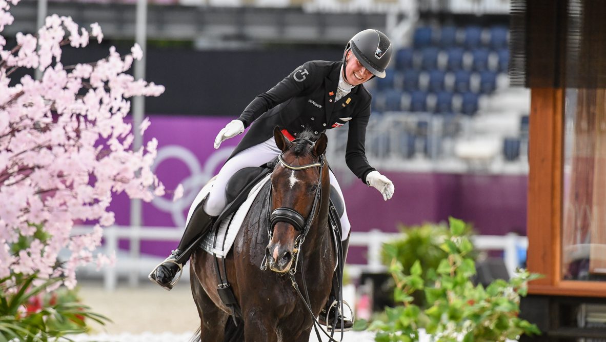 Nanna Skodborg Merrald pats Zack after finishing the grand prix special at the Tokyo Olympic dressage competition