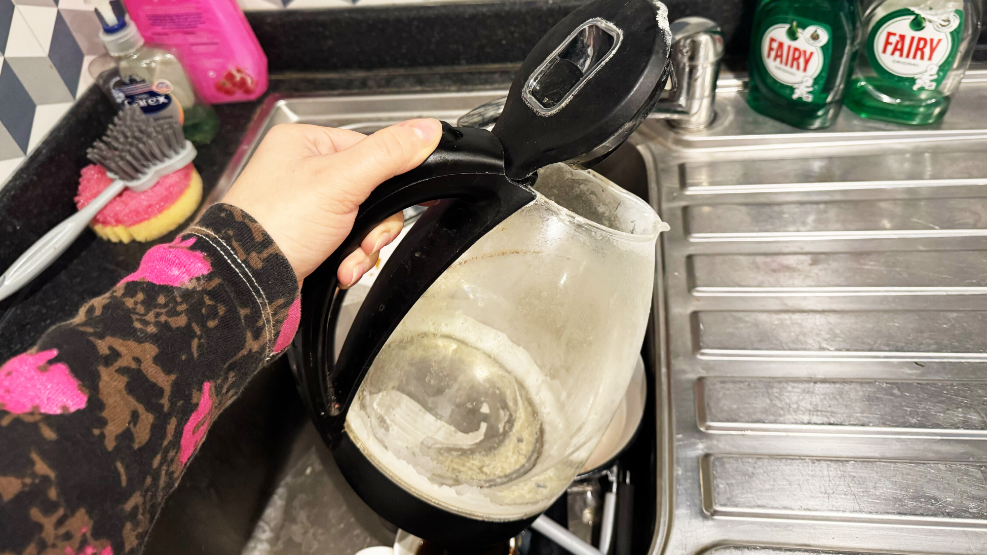 Kettle is emptied into the sink