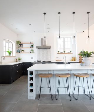 Light and dark colour contrast kitchen with pale blue island and dark cabinets