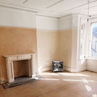 Before shot showing period living room with fireplace