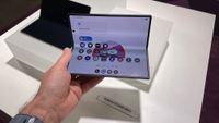The Samsung Galaxy Z Fold8 Ultra folded in the hand on a stand at the press launch.