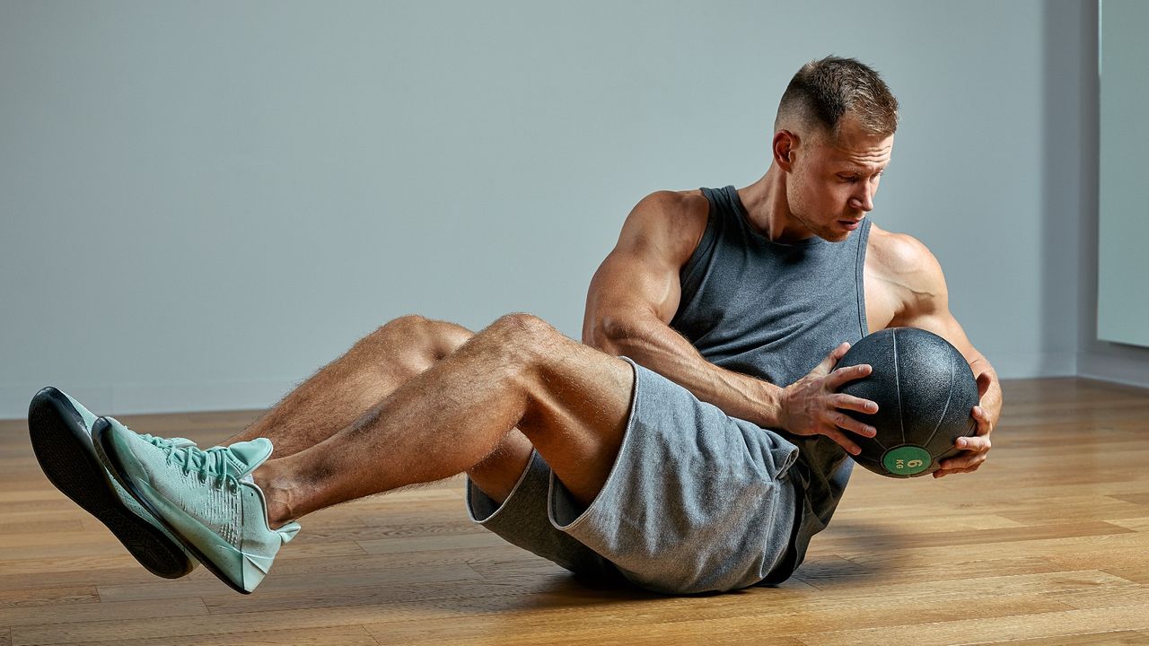 Man doing Russian twists