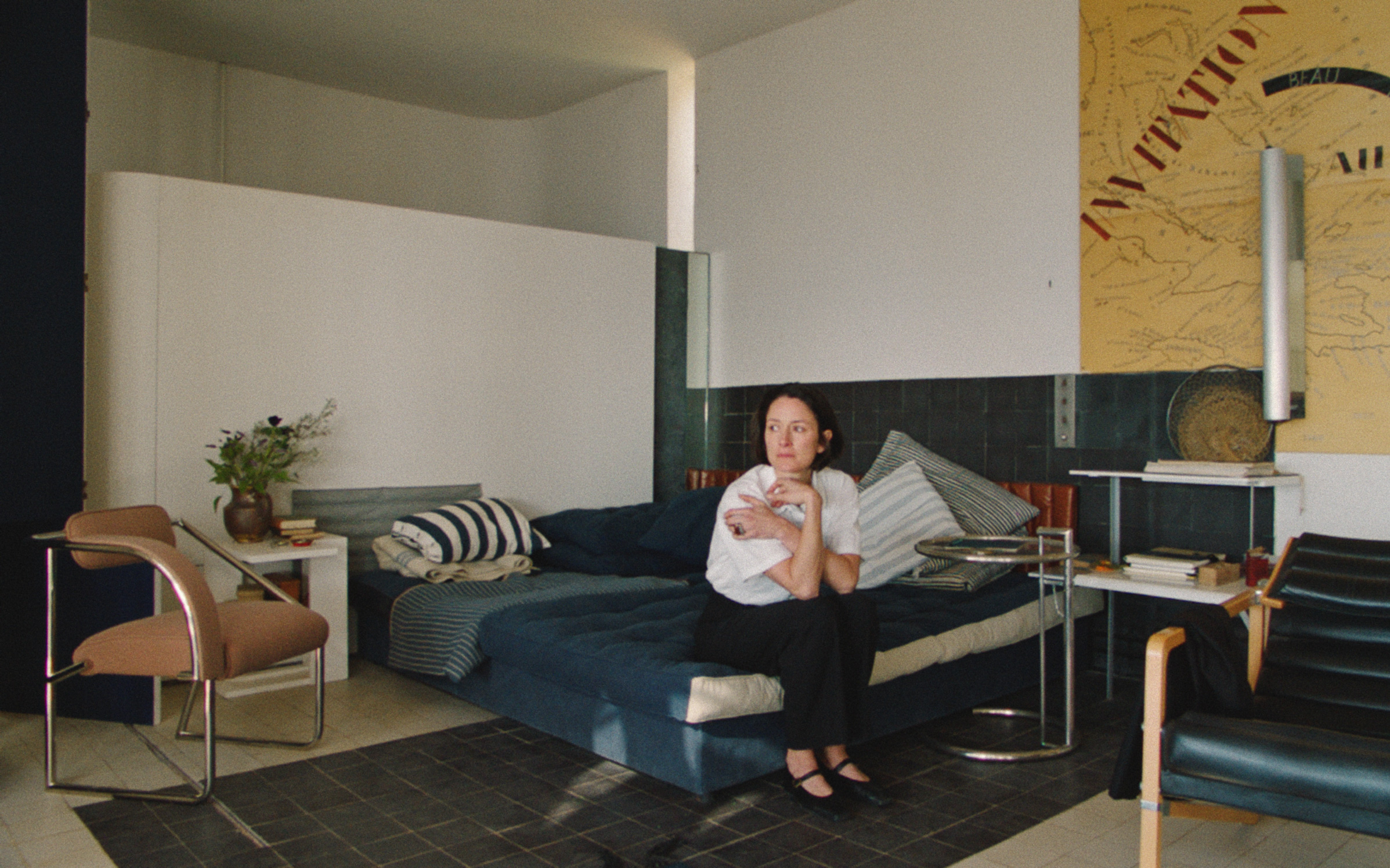 eileen gray in a bedroom surrounded by furniture