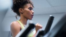 How to increase lung capacity: Close-up of a woman running on a treadmill