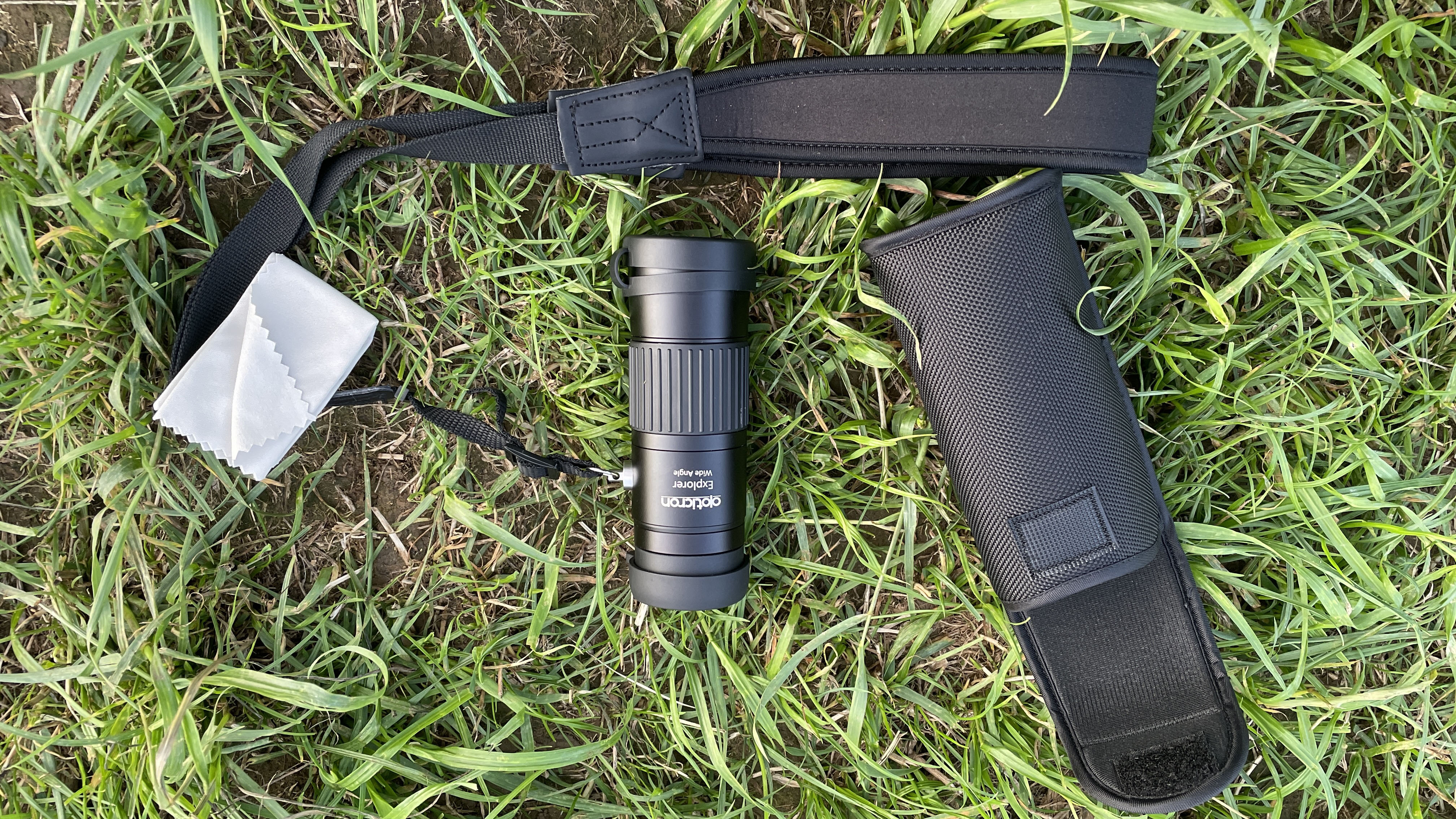 Opticron Explorer WA ED-R 8x42 monocular and accessories mounted on the ground.