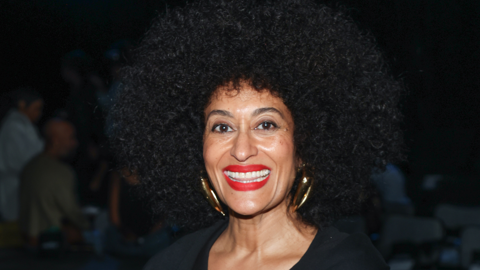 Tracee Ellis Ross wearing red lipstick and her afro hairstyle