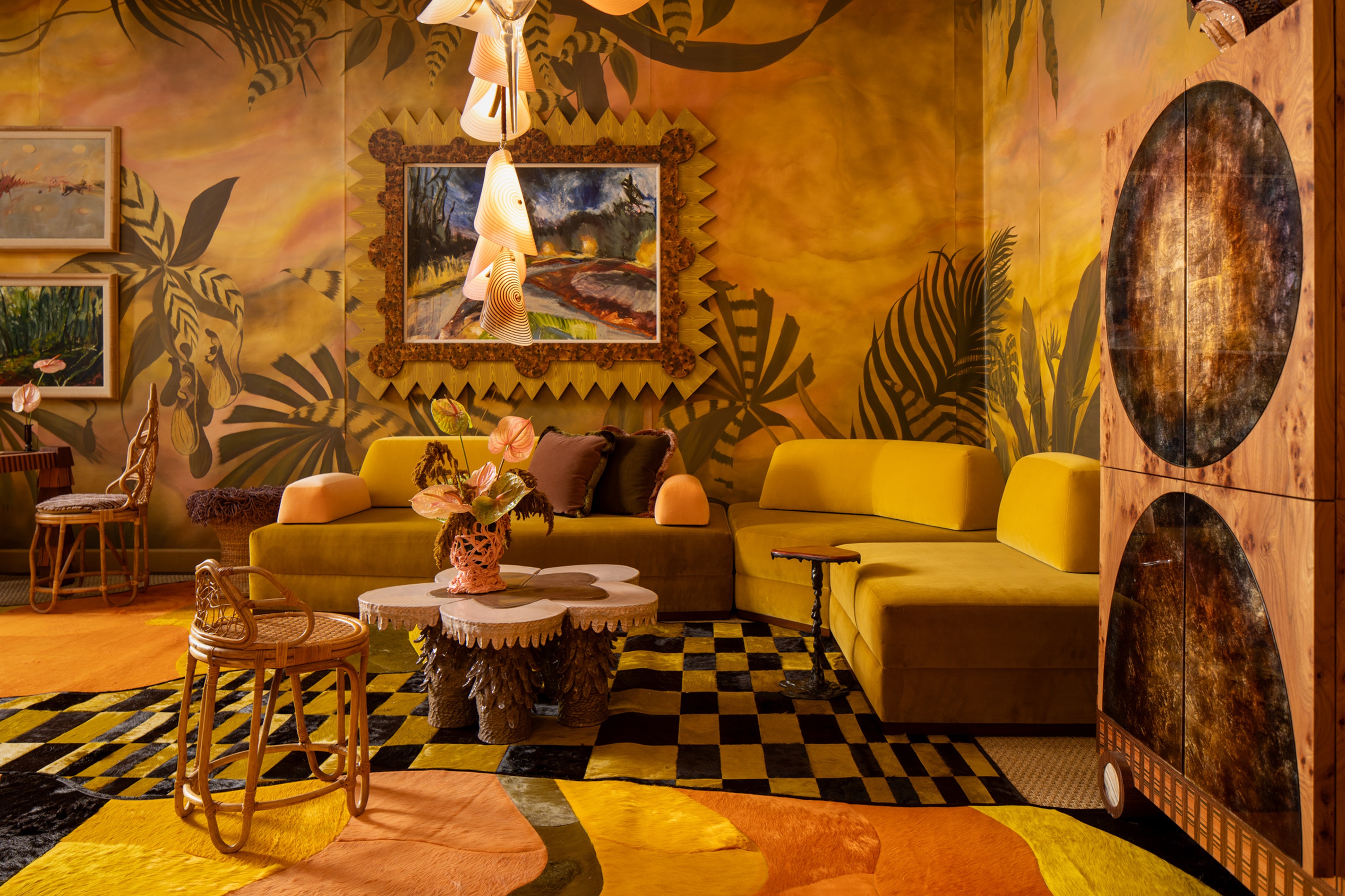 a yellow room with tropical wallpaper, a yellow sofa, and checkered rug